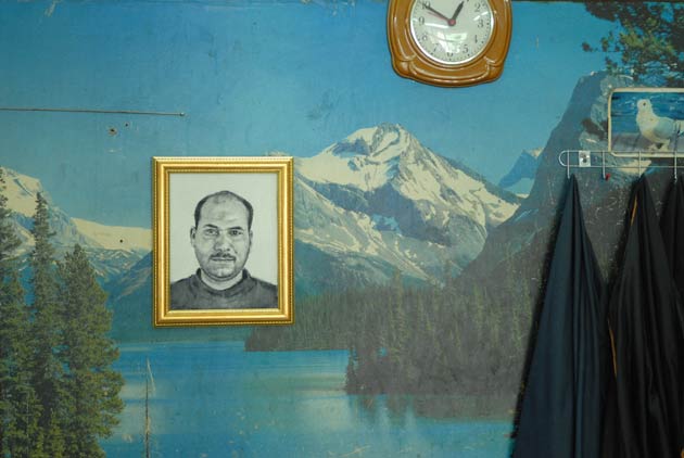 A portrait hangs on wallpaper in Hebron's Old City