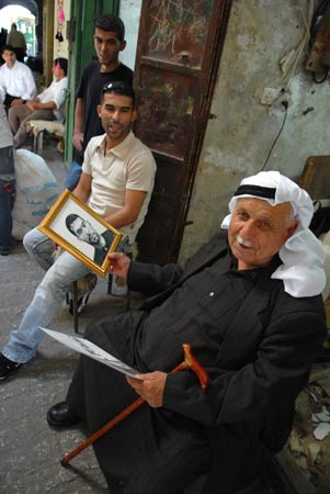 Two residents show off their portraits painted by Caspar Hall