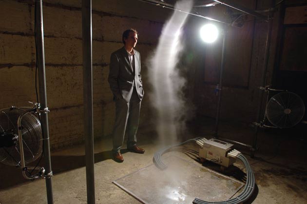  Alistair McClymont and his artwork Limitation of Logic and Absence of Certainty which is a tornado of water vapour created by electric fans, in the basement of of Shoreditch Town Hall as part of Concrete and Glass, an art and music festival, Shoreditch, London