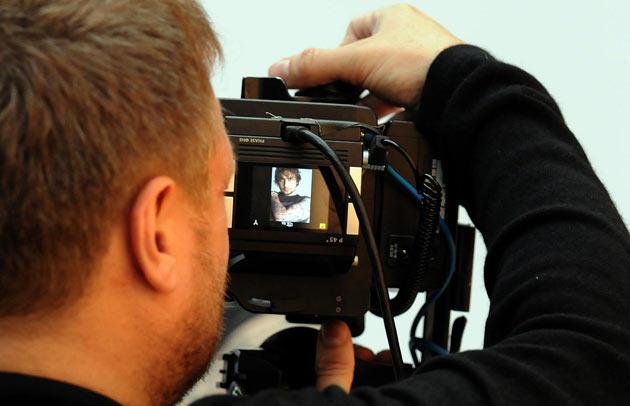 Rankin looks through the viewfinder