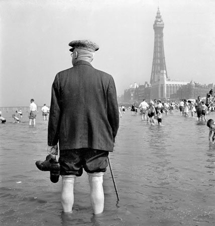 A man with walking stick on Blackpool beach