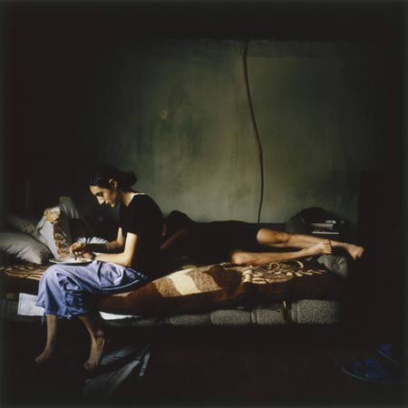 Slavica Feeds her Baby Son Nikola while her Husband Nebojsa Sleeps, by Ivor Prickett