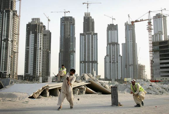 akistani construction workers take a break from work