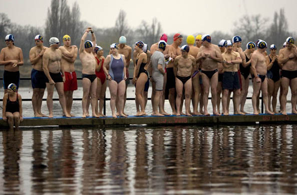 Members of the Serpentine swimming club line up for the start of the traditional Christmas day swimming race in Hyde Park's Serpentine lake