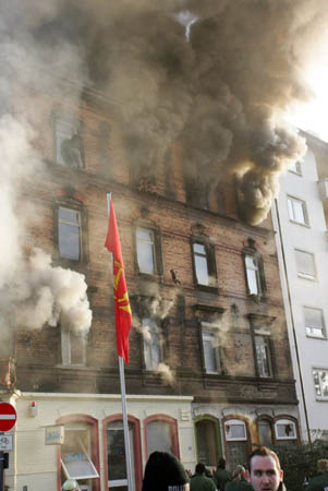 A baby is dropped from the fourth floor of an apartment building that has caught fire