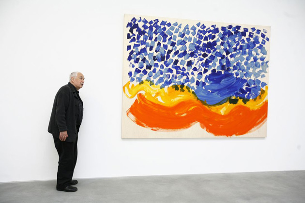 Howard Hodgkin poses in front of his new oil on wood painting
