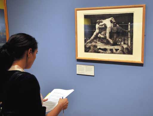 A visitor looking at George Bellow's A Stag at Sharkey's