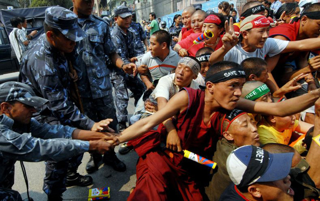 Nepalese policemen detain Tibetan activists in exile during an anti-Chinese demonstration near the Chinese Embassy