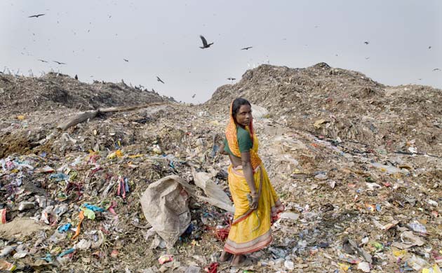 Delhi, India: Woman waste picking at Ghazipur landfill site 