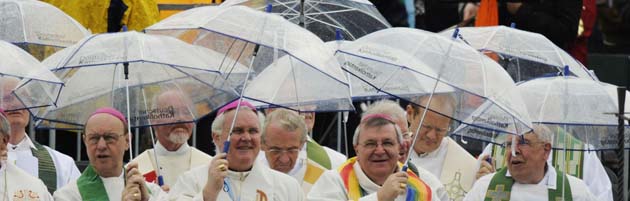 Priests shelter from the rain