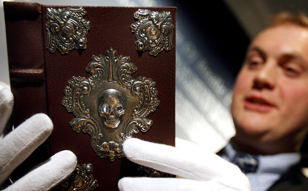 A Sotheby's employee holds The Tale of Beedle the Bard