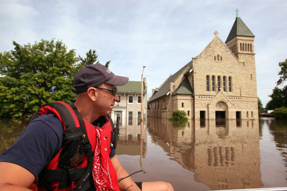 Firefighter Jason Lopez patrols a flooded street looking for stranded residents in Cedar Rapids