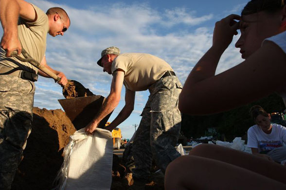 National guardsmen fill sand bags near Oakville 
