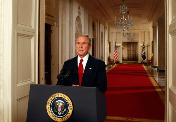 George Bush poses for photographers moments after speaking to the nation about the current financial crisis