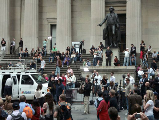 UnassignedThe presence of news media attract onlookers in front of Federal Hall, during coverage of nearby New York Stock Exchange