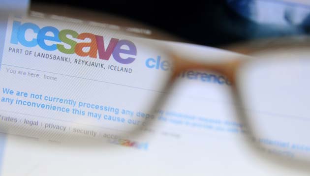 A page from Icesave online bank is seen on a computer screen through a pair of glasses