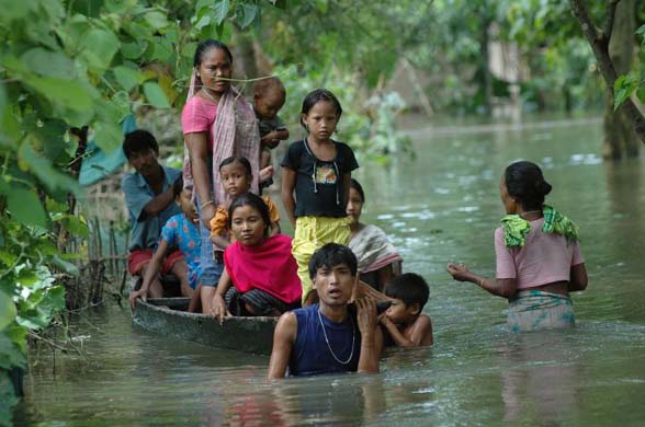 Villagers wade through floodwater