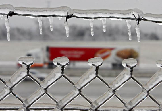 A frozen fence near a road