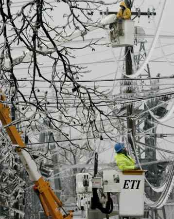 Utility crews work on power lines