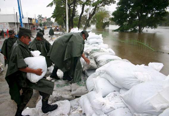 Mexican army soldiers build a dyke