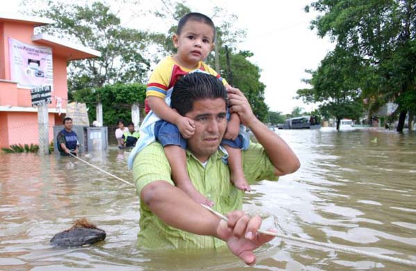 A man with his child in the flooded streets