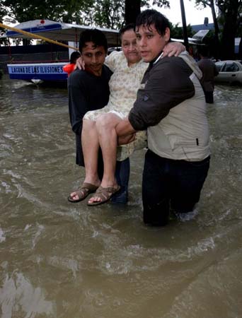 Rescuers help an elderly woman