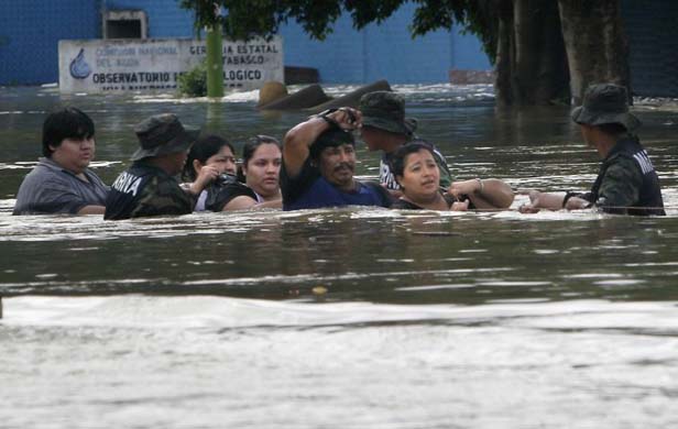 People being evacuated through the floodwaters