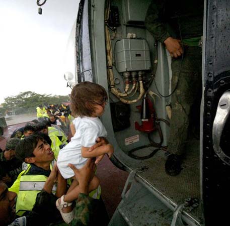 Rescues put a child onto a helicopter