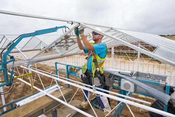 A worker installs glass panels