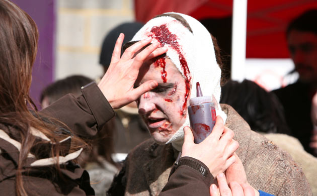 Man having fake blood applied to his head