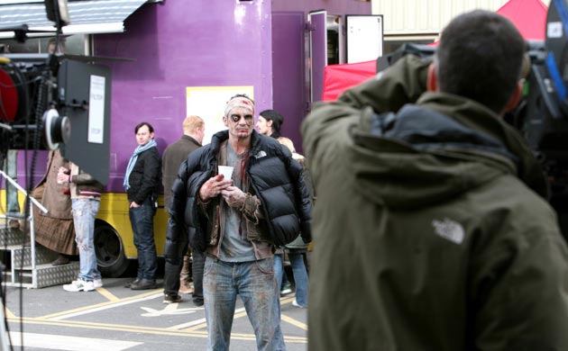 A camera operator sets up