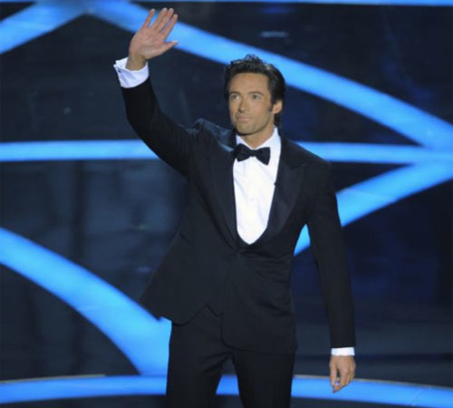 Host Hugh Jackman waves to audience at the opening of the ceremony