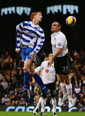 Dave Kitson of Reading and Danny Murphy of Fulham challenge for the ball