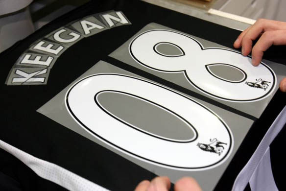 A Newcastle club shop worker prints up a shirt after Keegan was named as Newcastle's new manager