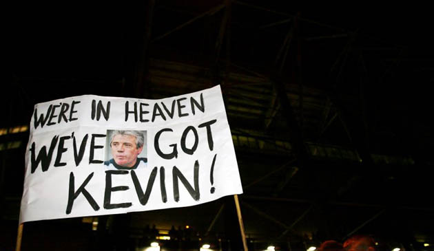 A fan holds a banner celebrating Kevin Keegan's return
