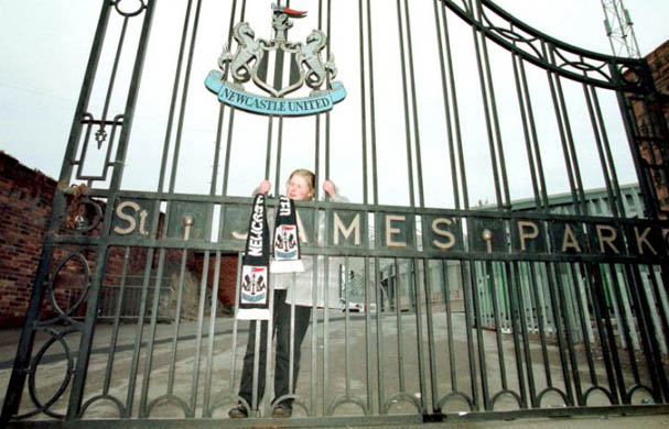 A young fan ties her scarf to to the gate as a gesture of farewell to Kevin Keegan
