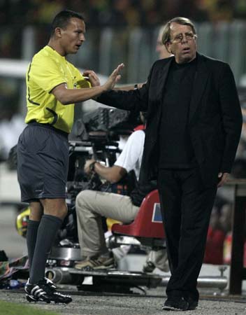 Ghana's coach Claude Le Roy and official Haimoudi Djamel during match between Ghana and Guinea