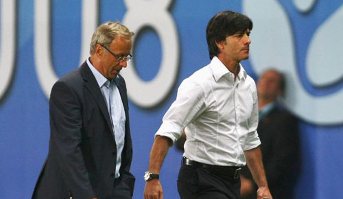 Loew and Hickersberger take the long walk from the pitch.