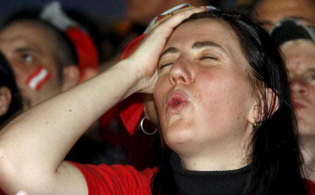 An Austria fan begins to cope with the news that her team are going out of the competition without winning a single game.