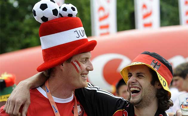 Fans share a joke before Austria v Germany