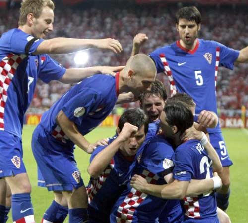 Klasnic is mobbed by jubilant team-mates after his emotional strike against Poland.