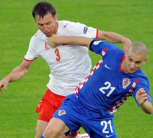 The Croatian forward Mladen Petric, right, and Polish defender Jakub Wawrzyniak during the early stages of the match in Klagenfurt. Photograph: Vincenzo Pinto/AFP
