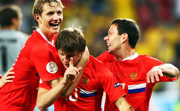 Andrei Arshavin is mobbed by team mates