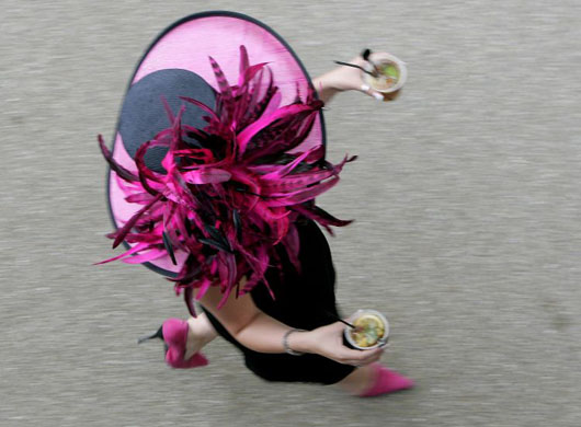 A woman carries drinks to the Royal enclosure