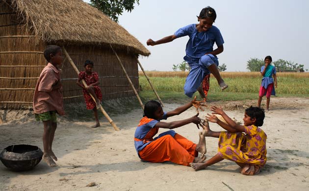 Children play in front of their house