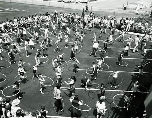 At the height of the hula hoop craze, various techniques are demonstrated in Los Angeles