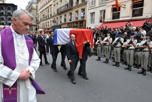 Pallbearers carry the coffin of YSL to the Saint Roch church in Paris 