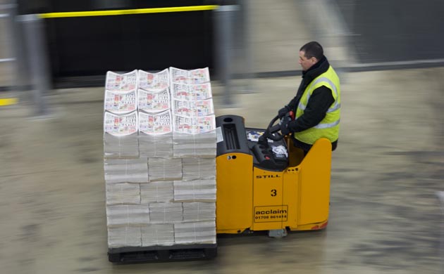 Fork-lift moves palette of papers