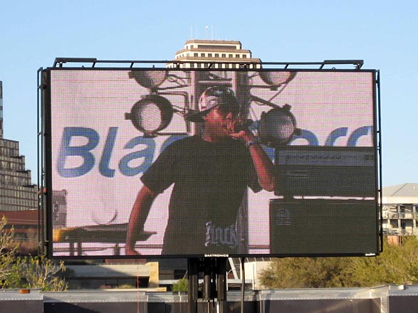 Talib Kweli on a giant TV screen at Lady Bird Lake