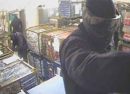 2.01am A robber stands by the cages of money